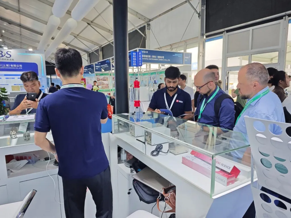 DSP team demonstrating chromatography products to international visitors at expo