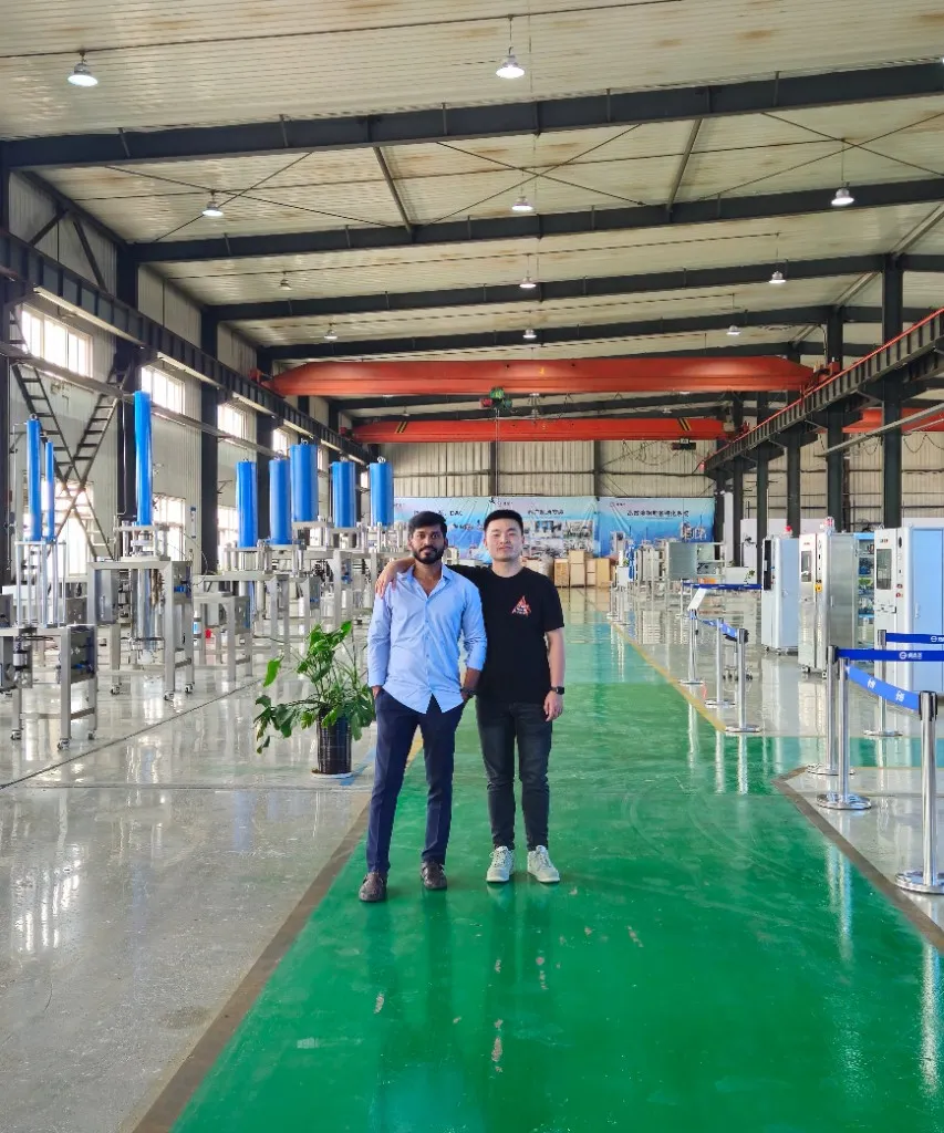 DSP team members at the chromatography manufacturing facility with DAC columns in background