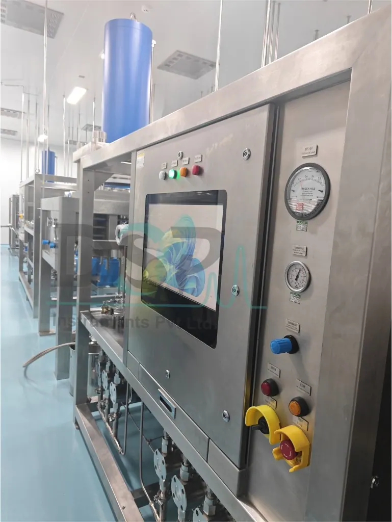 Close-up of stainless steel chromatography control panel with gauges and emergency stop